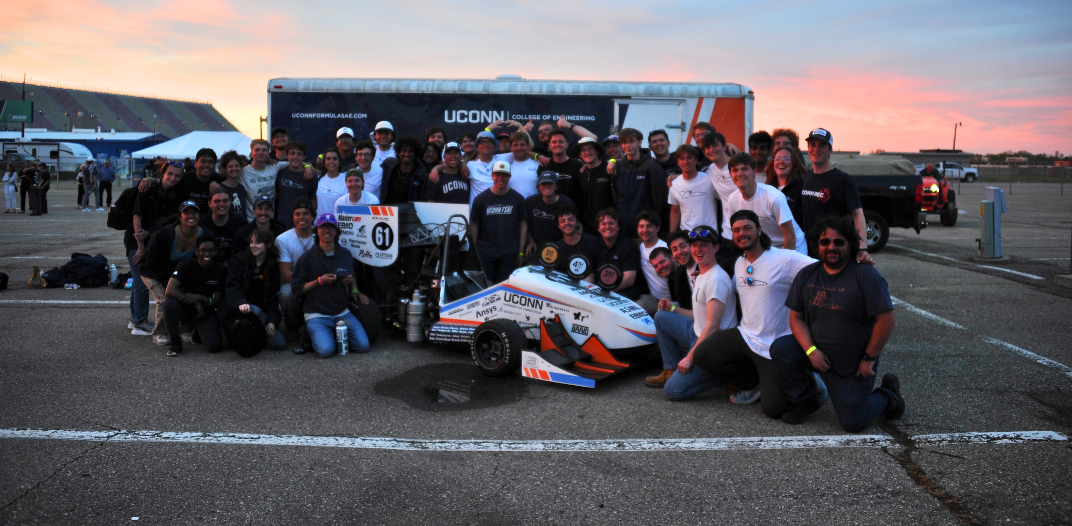 UConn Formula SAE cars on track at golden hour