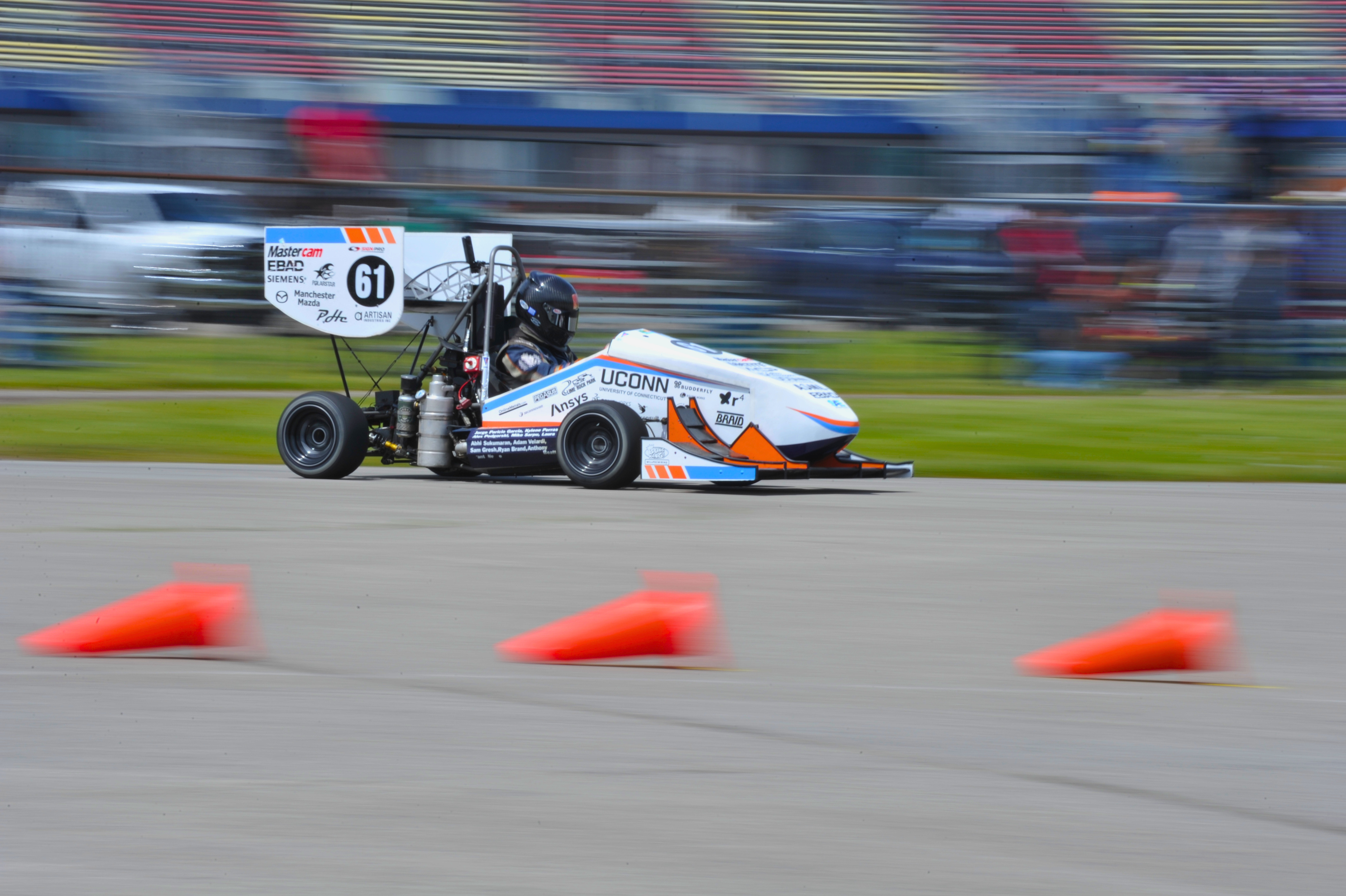 The UConn Formula SAE team with both competition cars
